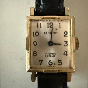 Elegant and petite La Marque Black Leather Strap Watch with Gold Accents